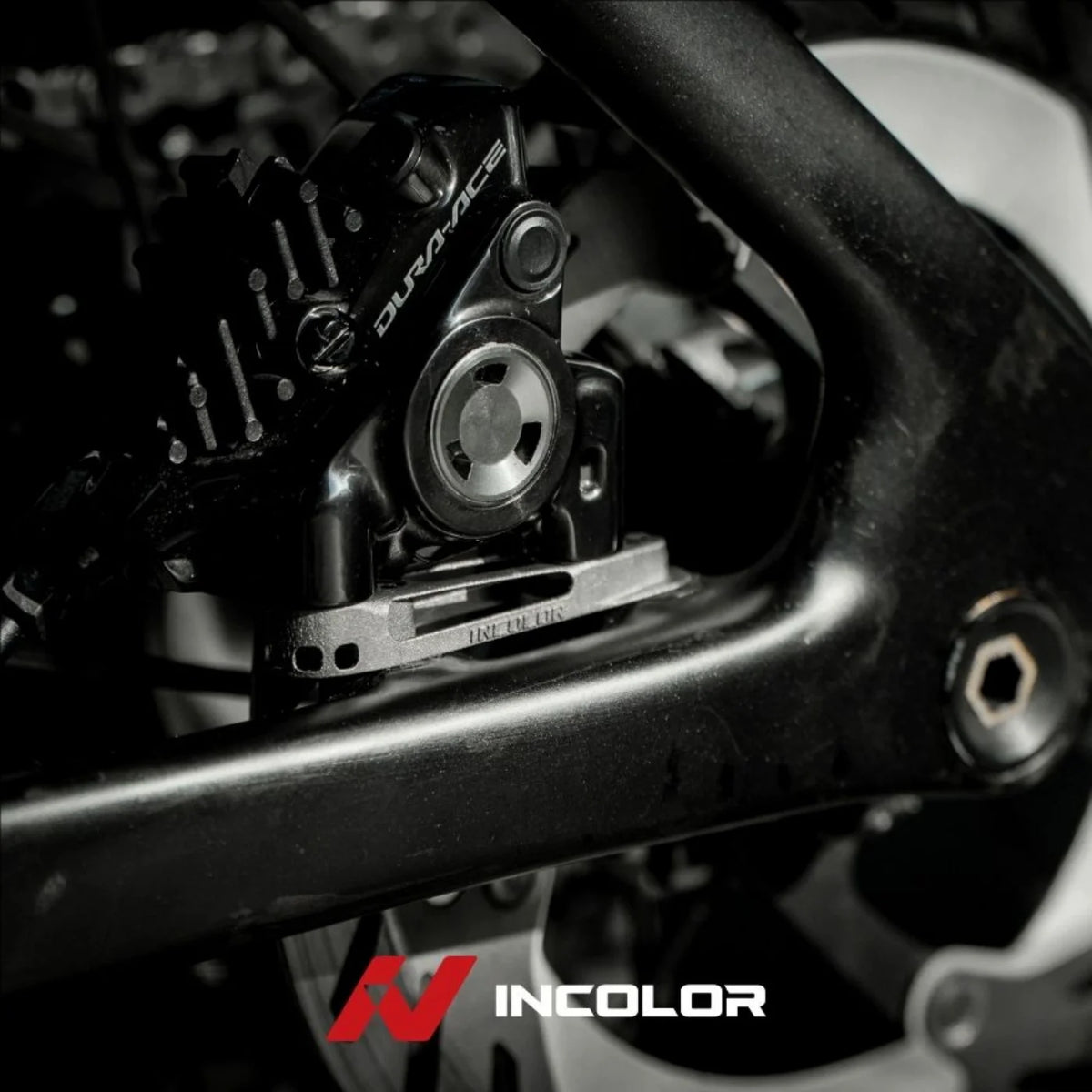 Incolor titanium rear brake mount fitted to a frame