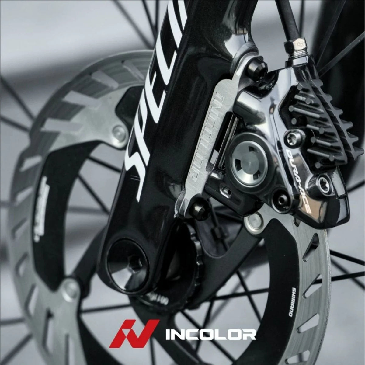 Incolor titanium front brake mount on a Specialized fork
